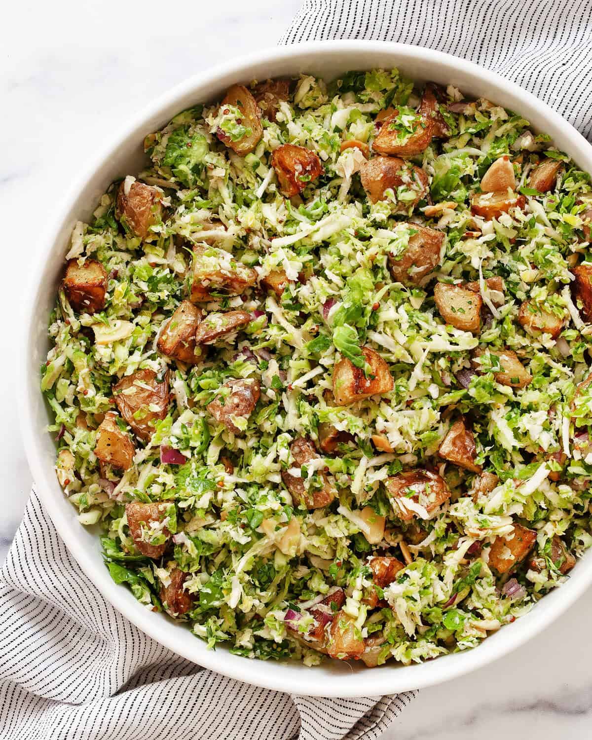 Roasted potato brussels sprout salad in a bowl.