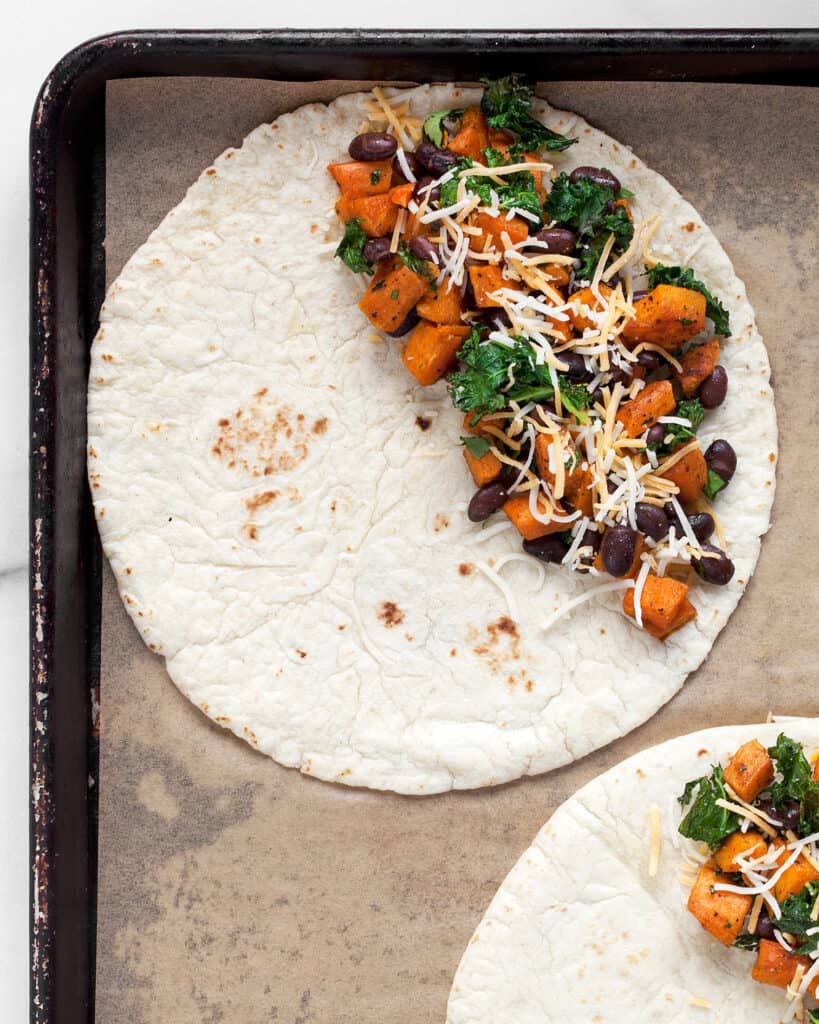 Assembling the quesadillas on a sheet pan