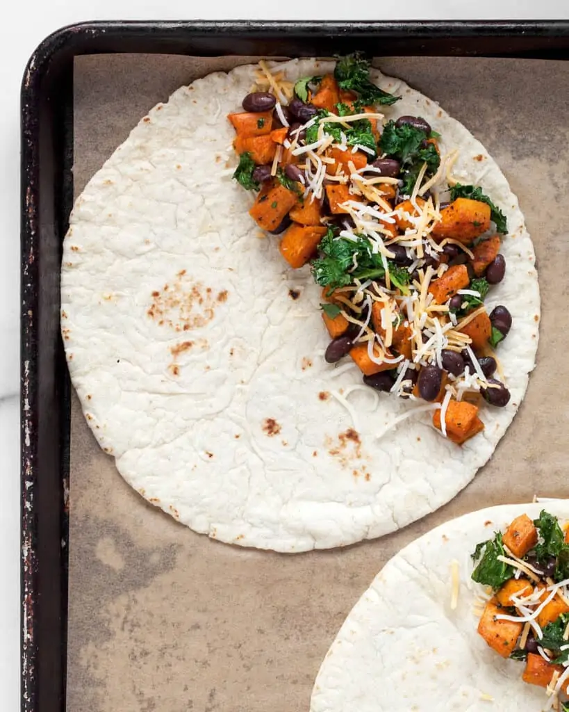Assembling the quesadillas on a sheet pan