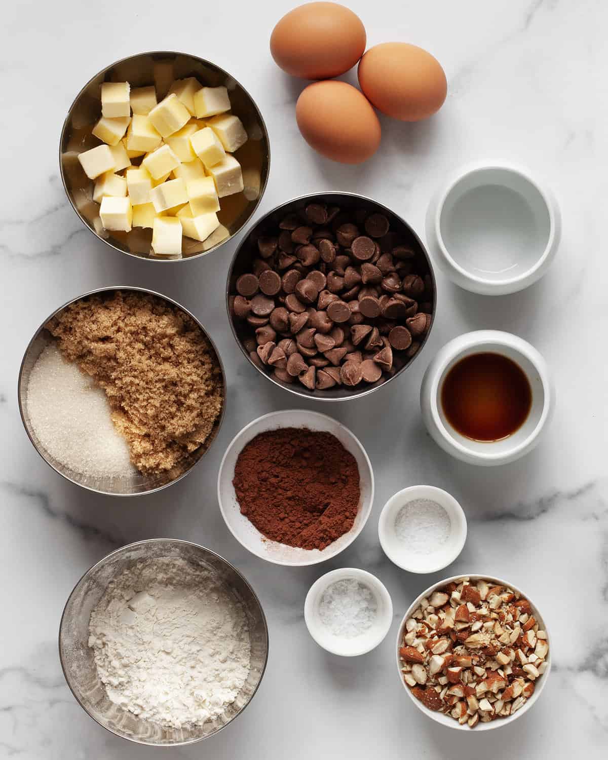 Ingredients including butter, sugars, chocolate chips, cocoa powder, flour, salt and eggs.