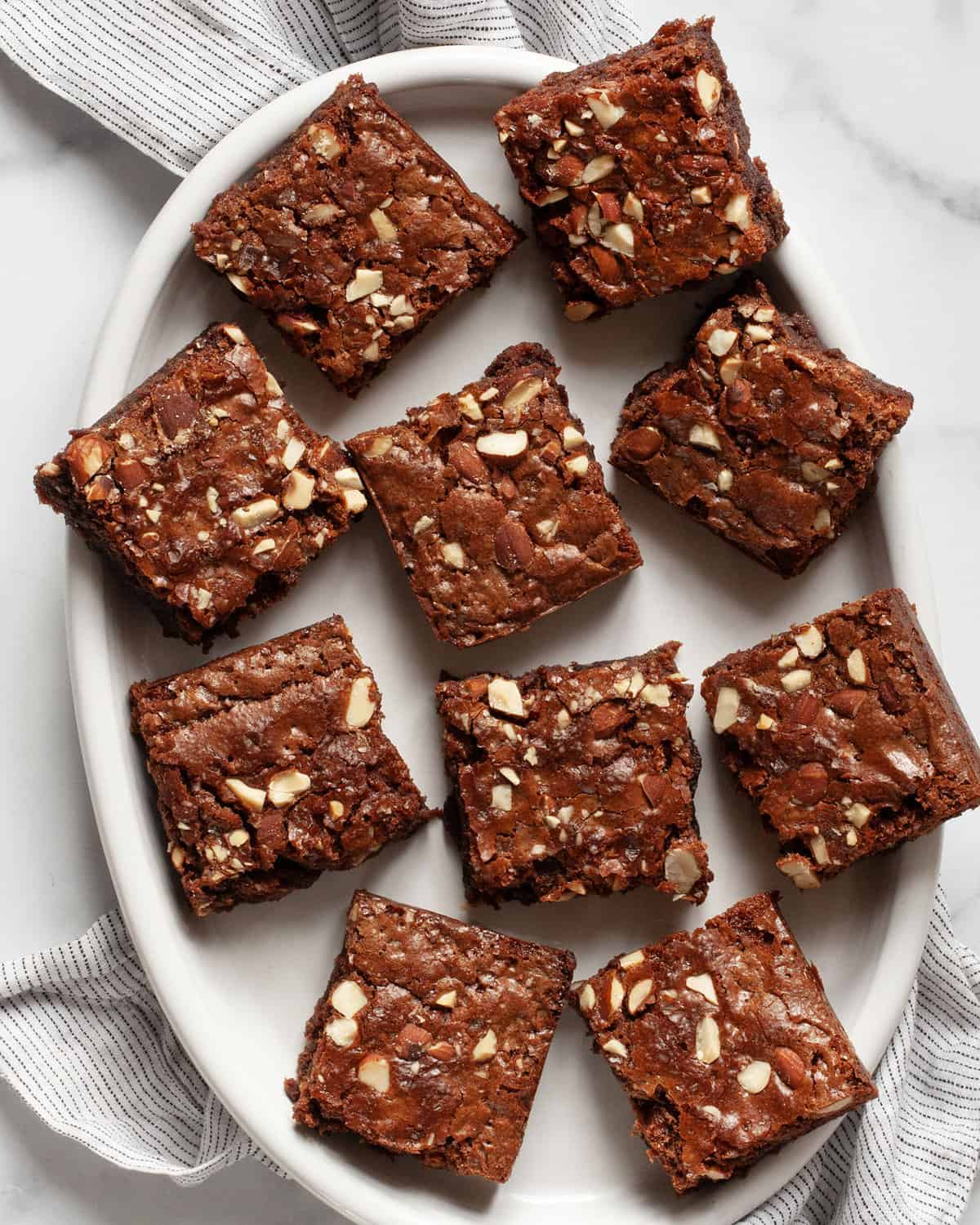 10 brownies on an oval plate.