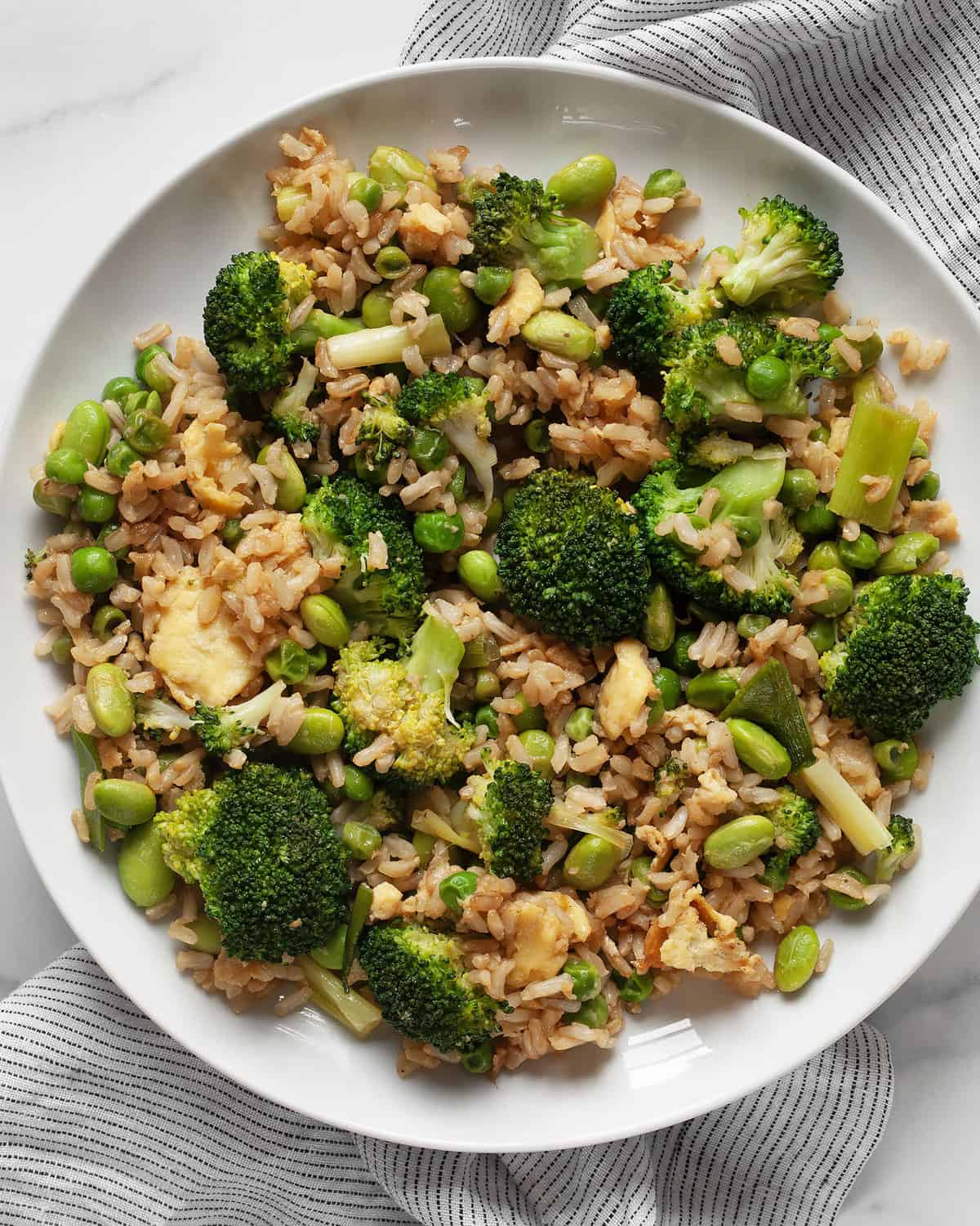 Broccoli, pea and edamame fried rice on a plate.