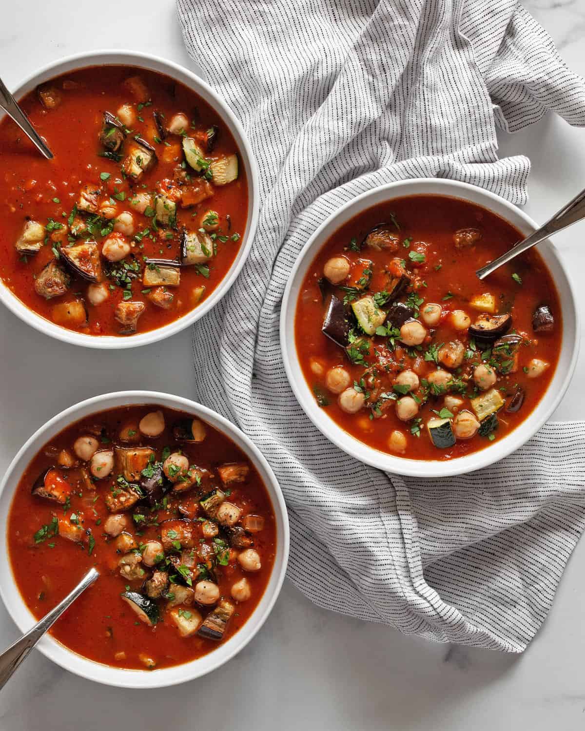 Three bowls of eggplant soup.