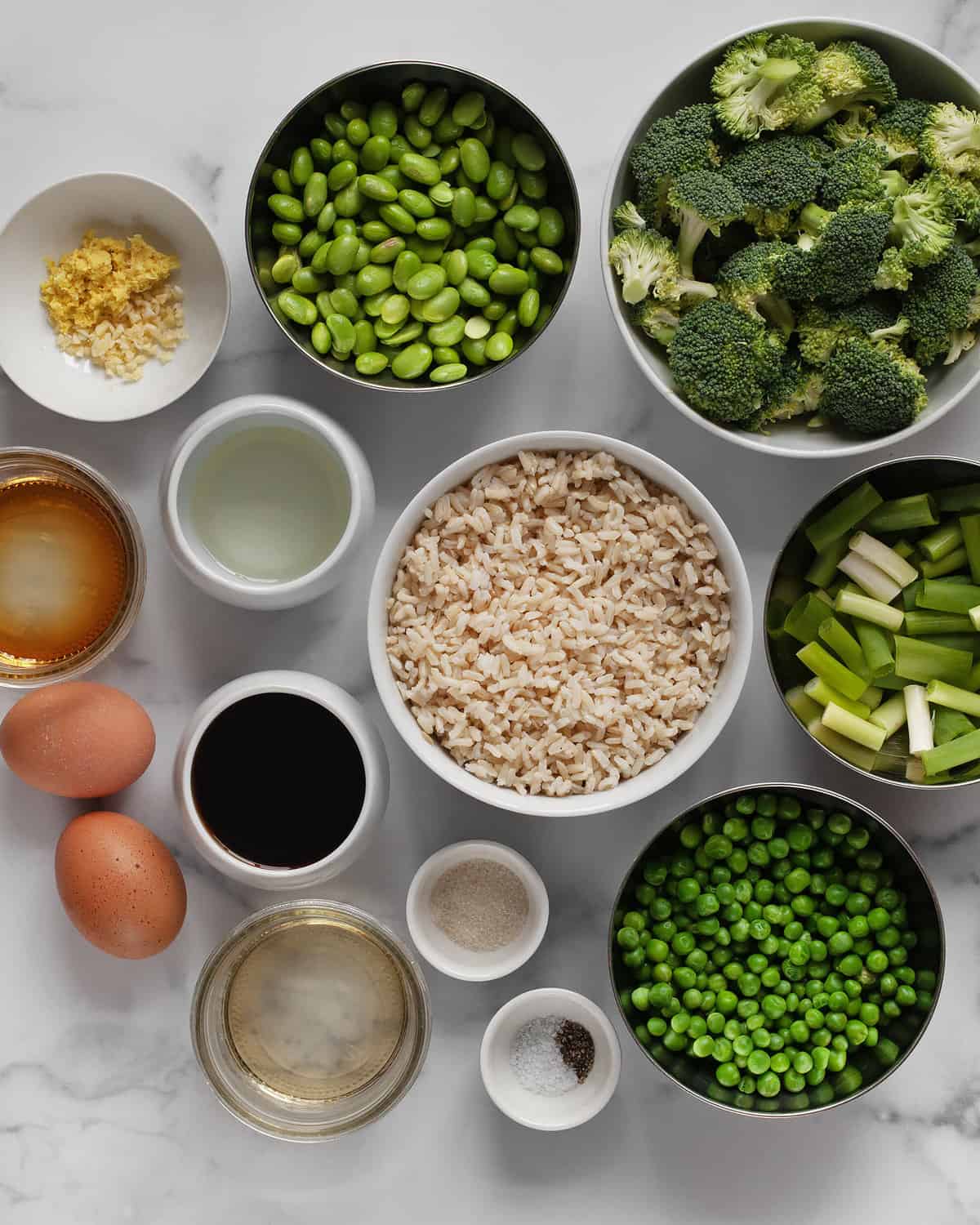 Ingredients including broccoli, peas, edamame, scallions, rice, eggs, oil, rice vinegar, ginger, garlic and soy sauce.