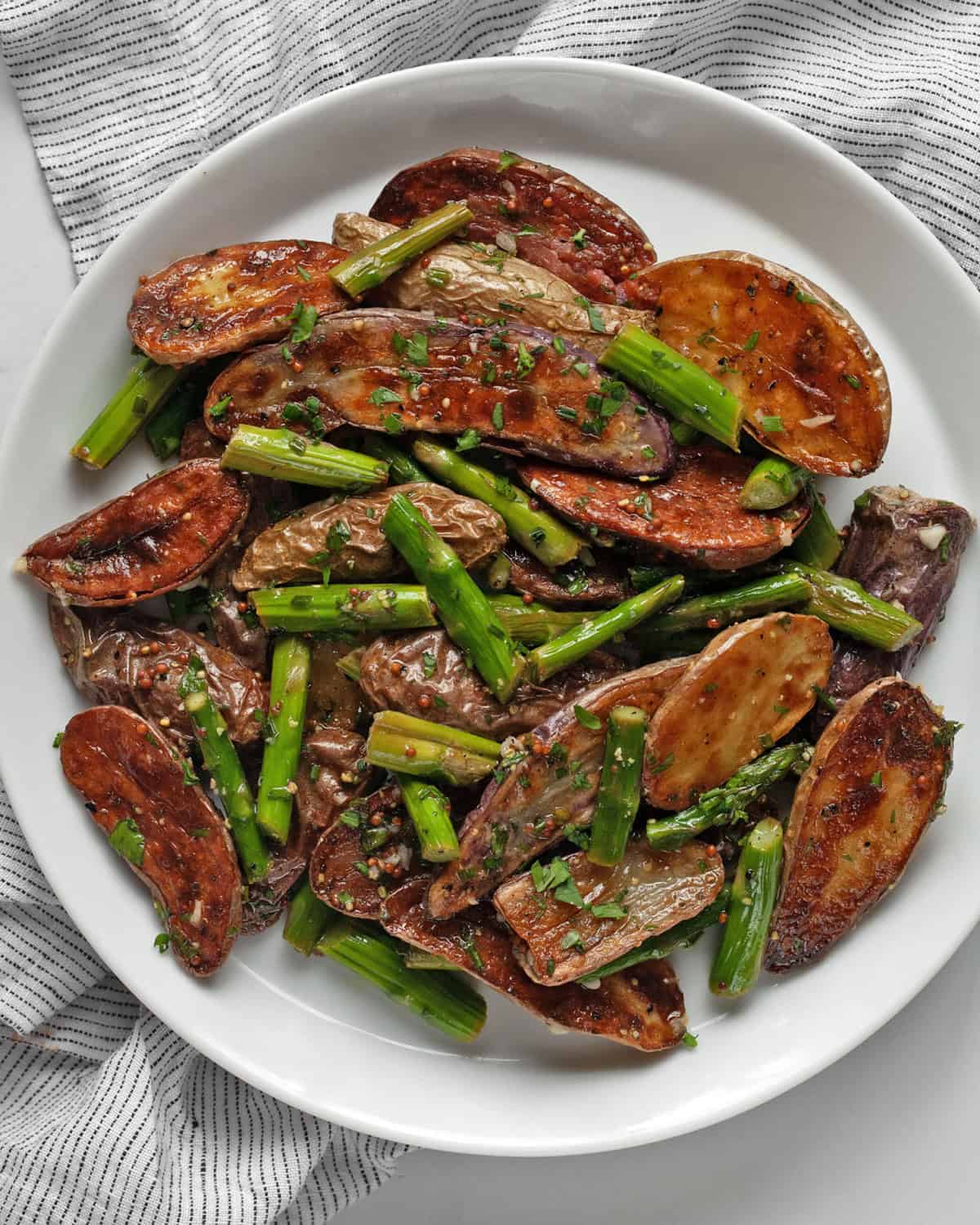 Roasted asparagus potato salad on a plate.