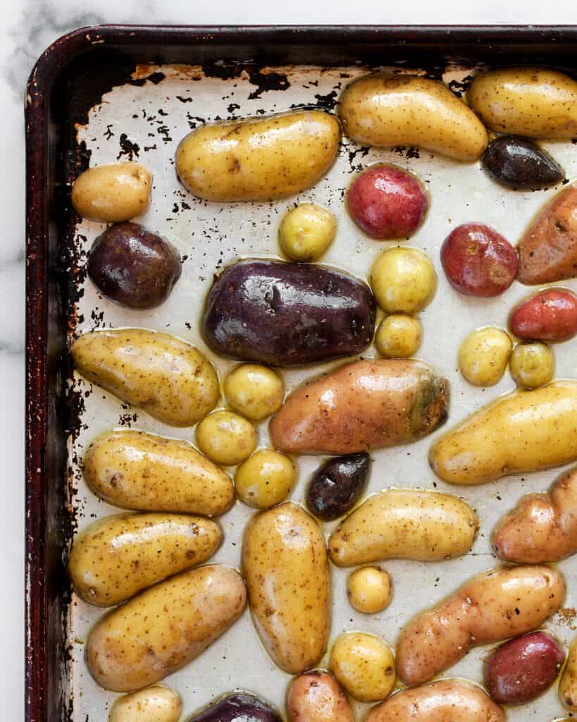 Halved fingerling potatoes on a sheet pan