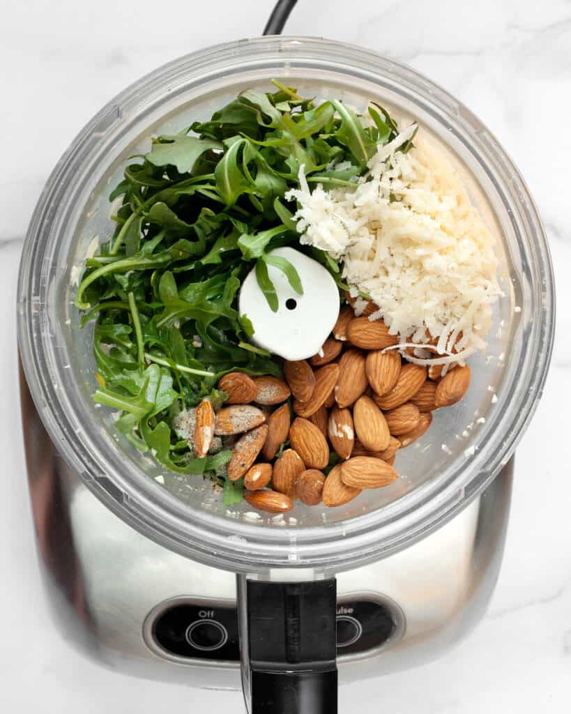 Make the arugula almond pesto in the food processor