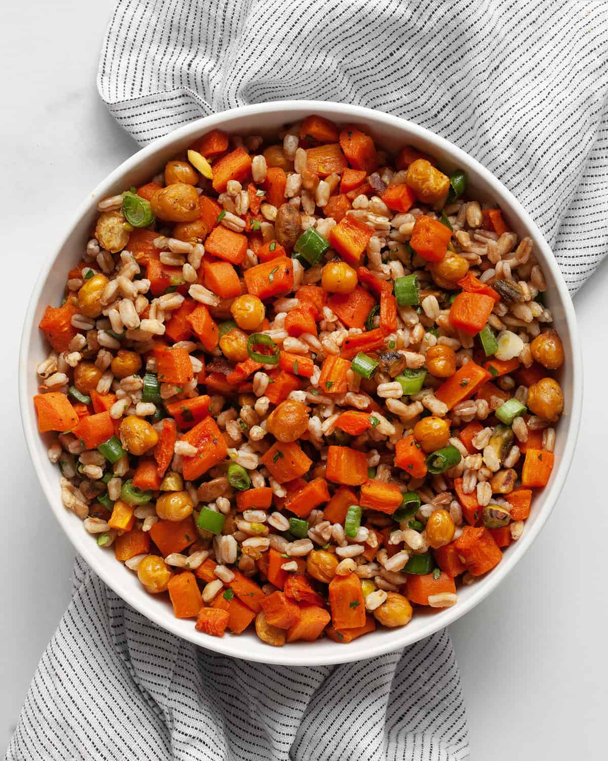 Farro with roasted carrots and chickpeas in a bowl.