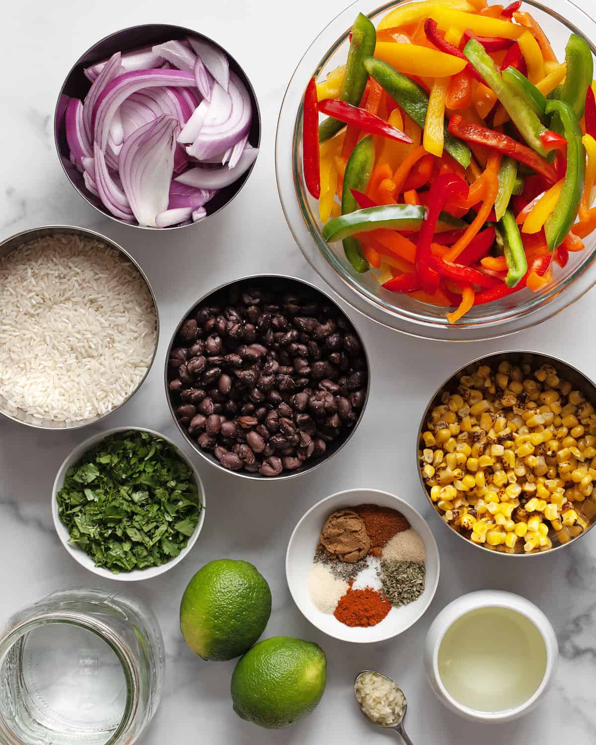 Ingredients including peppers, onions, bans, corn, rice, lime, oil and spices.