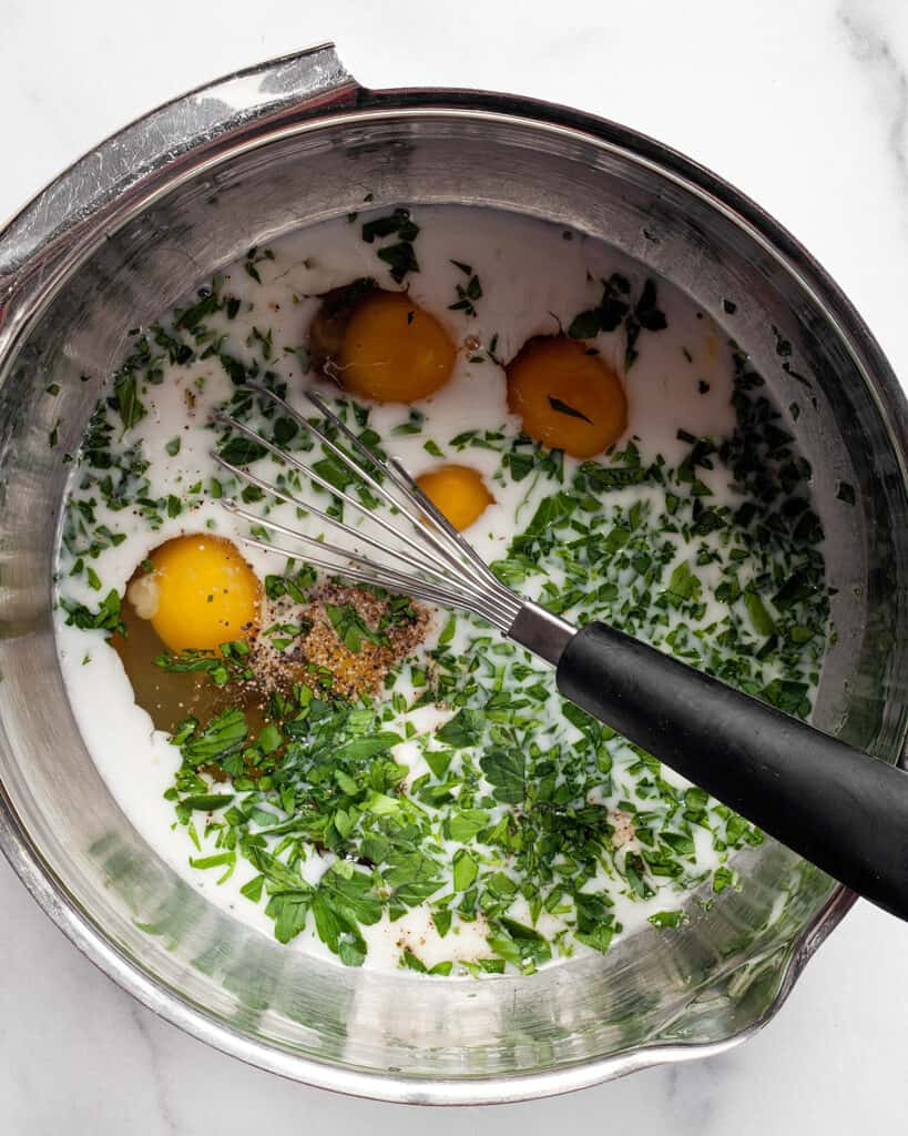 Whisk together the eggs, milk, herbs, and seasonings