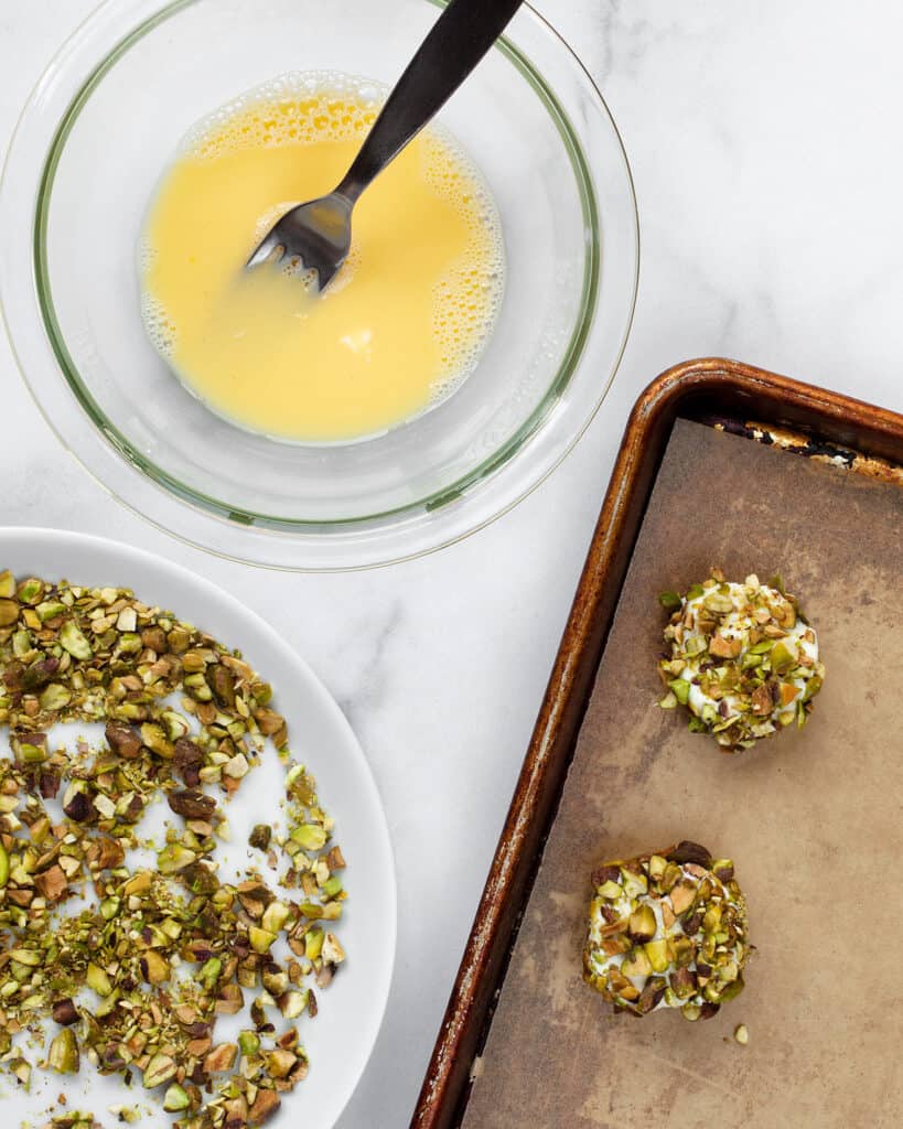Coat the goat cheese rounds in chopped pistachios