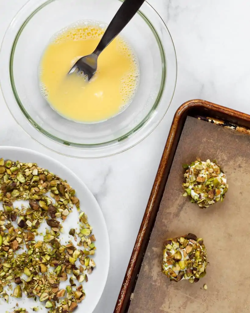 Coat the goat cheese rounds in chopped pistachios