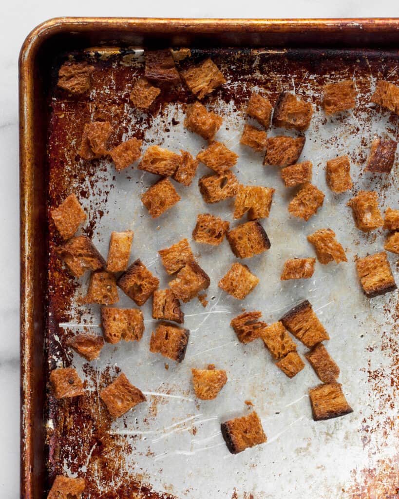 Toasted bread for croutons on a sheet pan