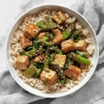 Sesame tofu and asparagus with brown rice in a bowl.
