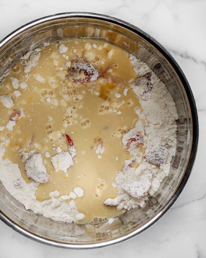 Stirring the wet ingredients into the dry ingredients in a bowl for the scone dough