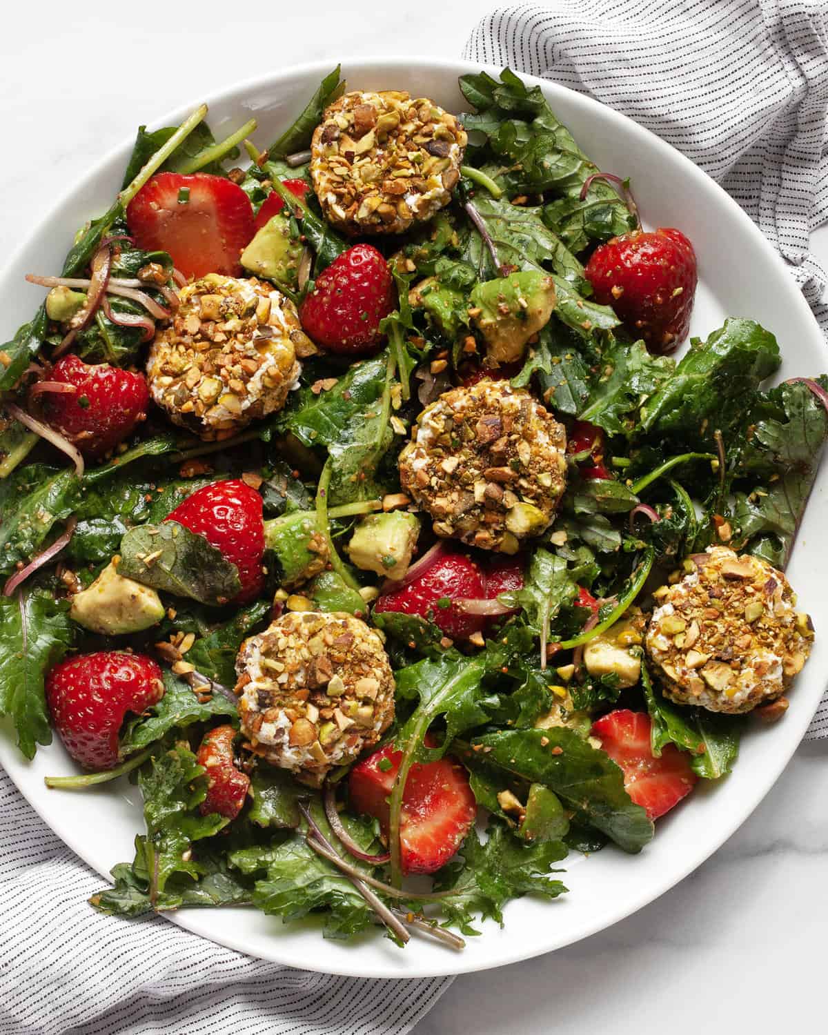 Strawberry goat cheese salad on a plate.