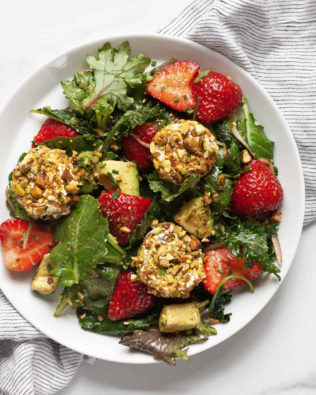 Strawberry goat cheese salad on a plate.