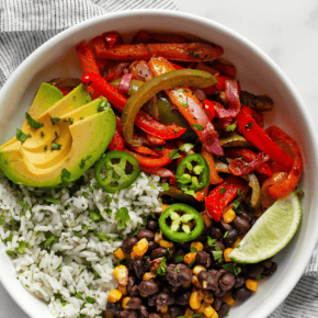 Veggie fajita bowl with roasted peppers and onions and cilantro lime rice.