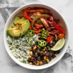 Veggie fajita bowl with roasted peppers and onions and cilantro lime rice.