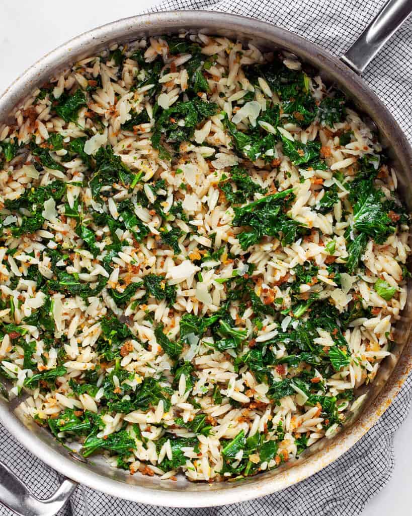 Orzo with lemon and kale in a skillet