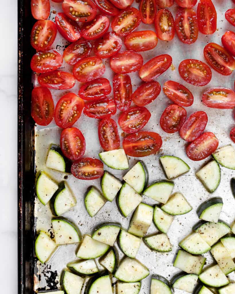 Cherry tomatoes and zucchini on sheet pan
