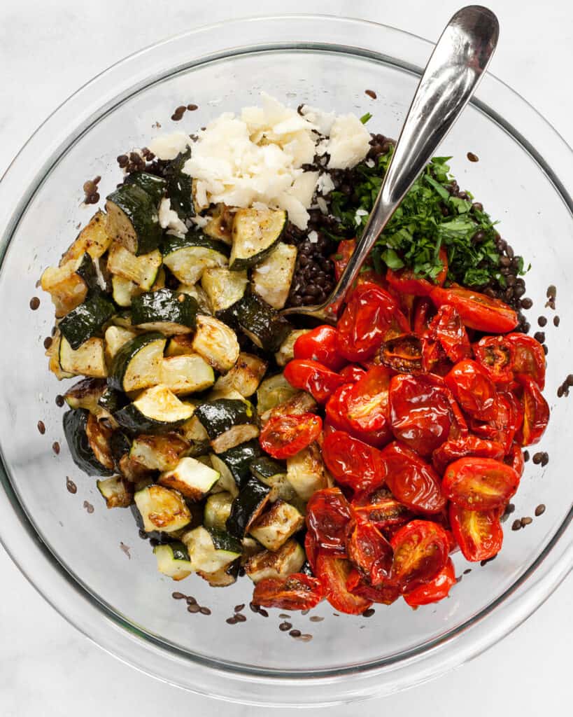 Tomatoes and zucchini in bowl with lentils