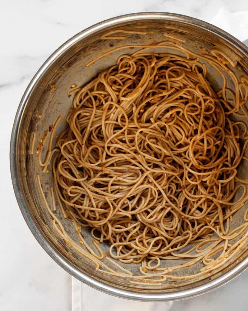 Stirring sauce into soba noodles