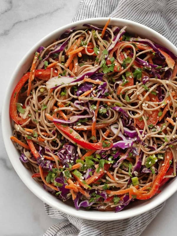 Salad with soba noodles, cabbage, carrots and bell peppers in a bowl.