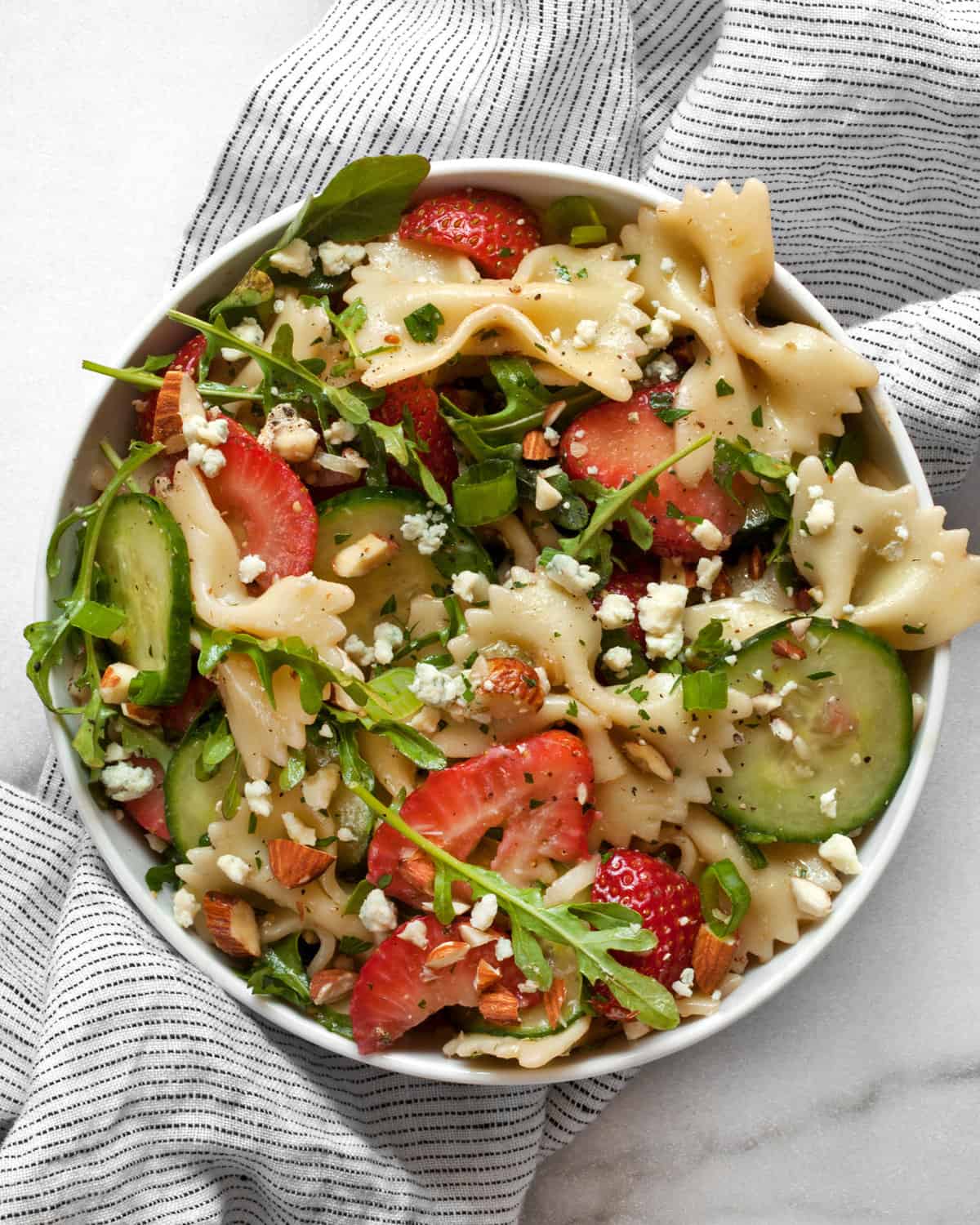 Strawberry cucumber pasta salad in a small bowl.