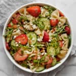 Easy pasta salad with strawberries and cucumbers in a bowl.