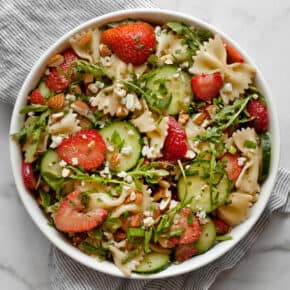 Easy pasta salad with strawberries and cucumbers in a bowl.