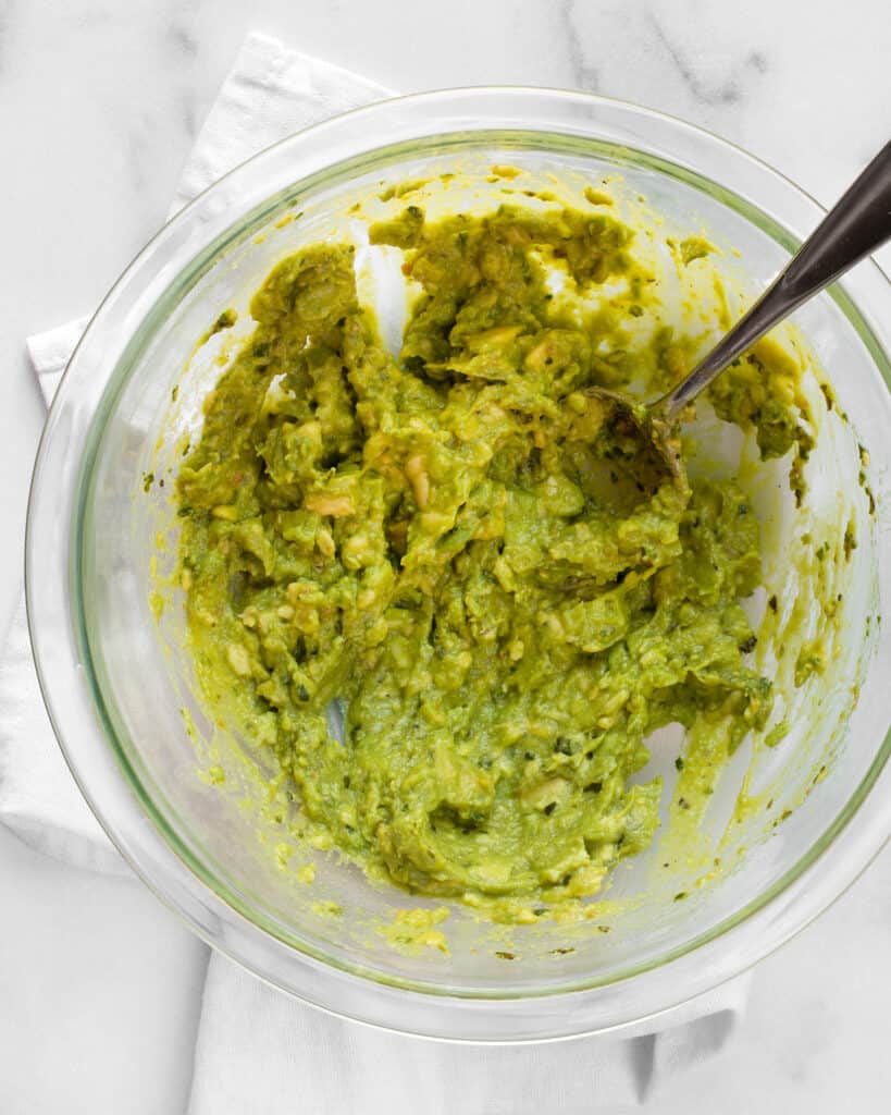 Mashed avocado with pesto in a bowl