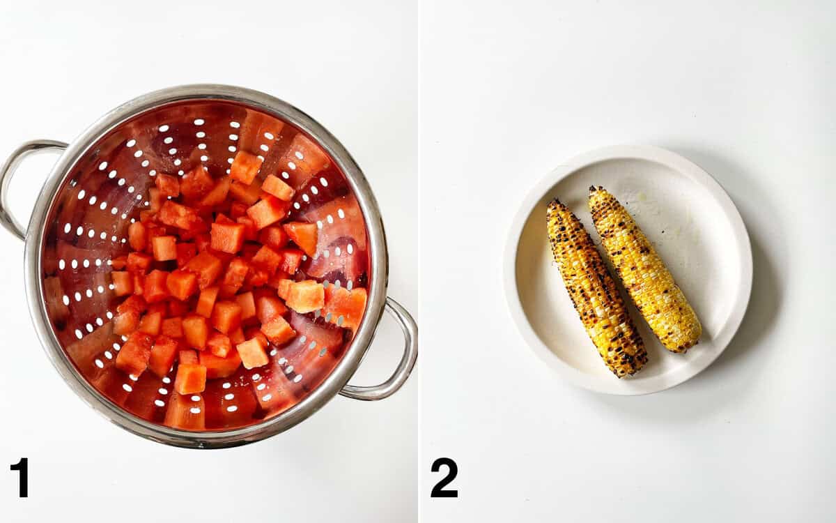 Cubed watermelon in a strainer. Two ears of grilled corn on a plate.