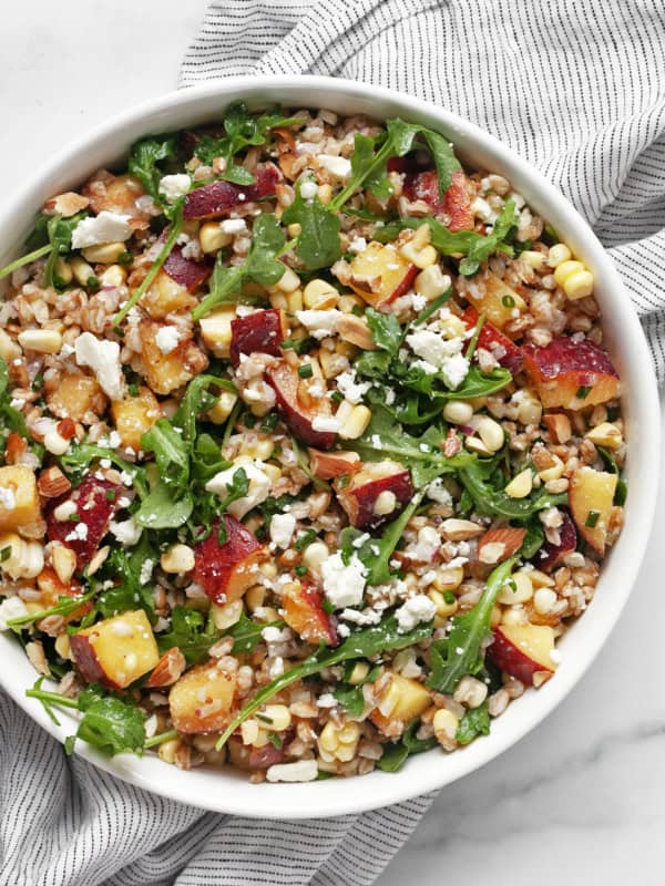 Peach corn farro salad in a bowl.