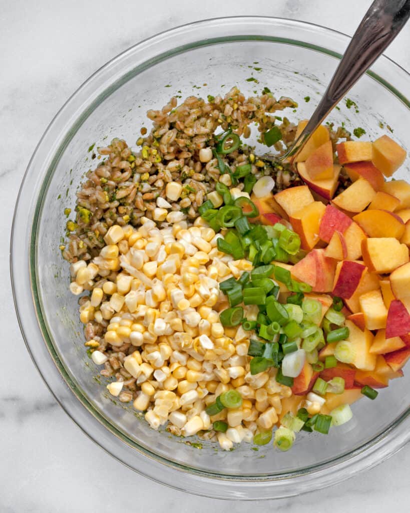 Combining the peaches, corn and farro