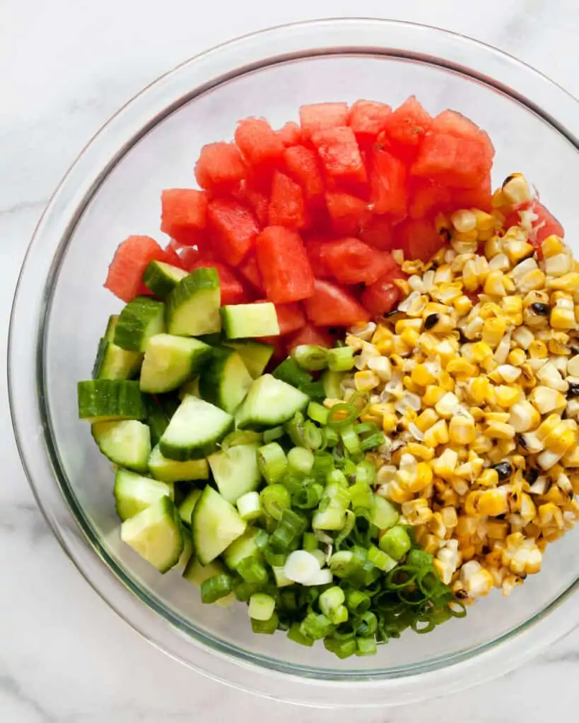 Salad ingredients include watermelon, cucumbers, grilled corn & scallions