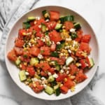 Watermelon cucumber corn salad in a bowl.