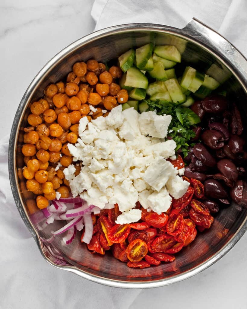 Ingredients for chickpea Greek salad in a bowl