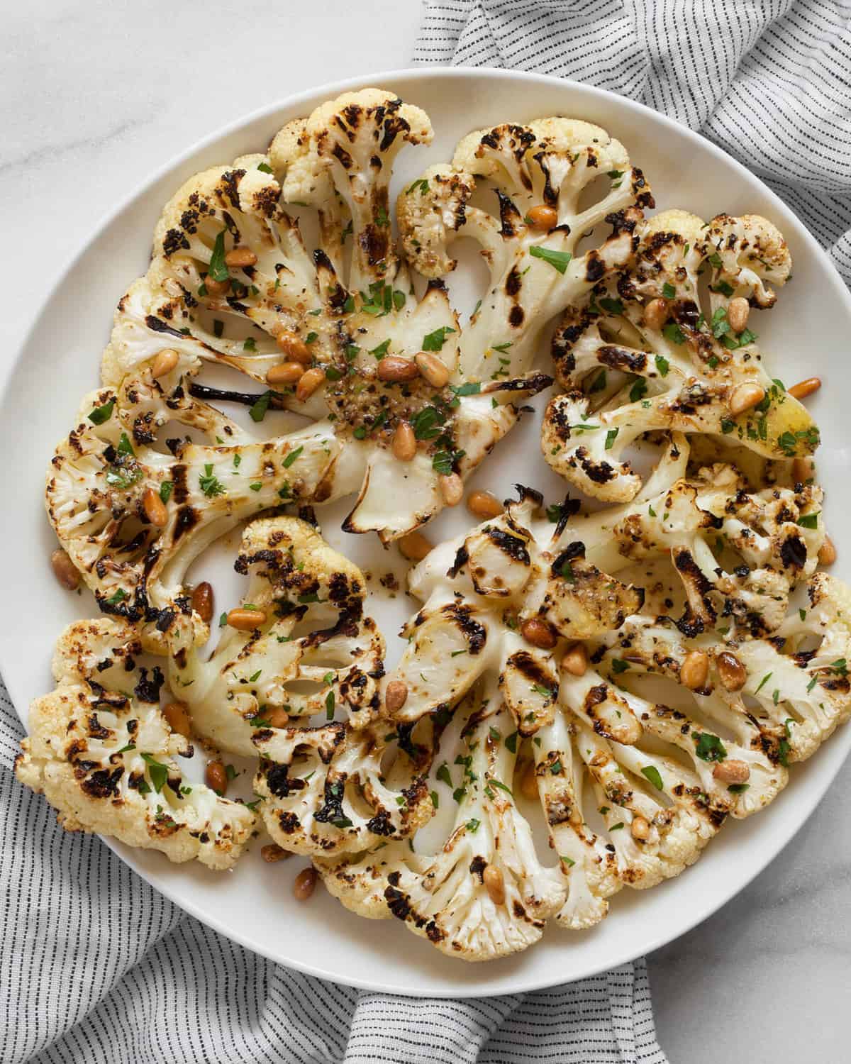 Lemon pepper grilled cauliflower on a plate.