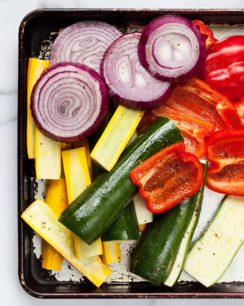 Sliced vegetables on sheet pan