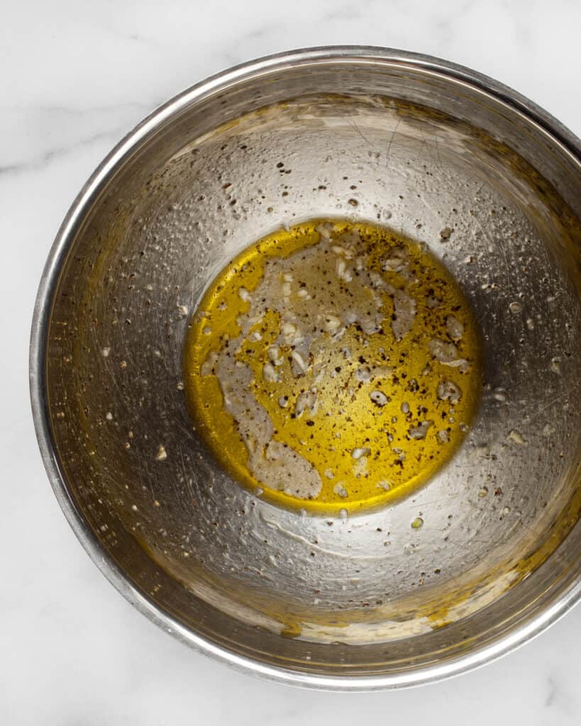 Whisking vinaigrette in bowl