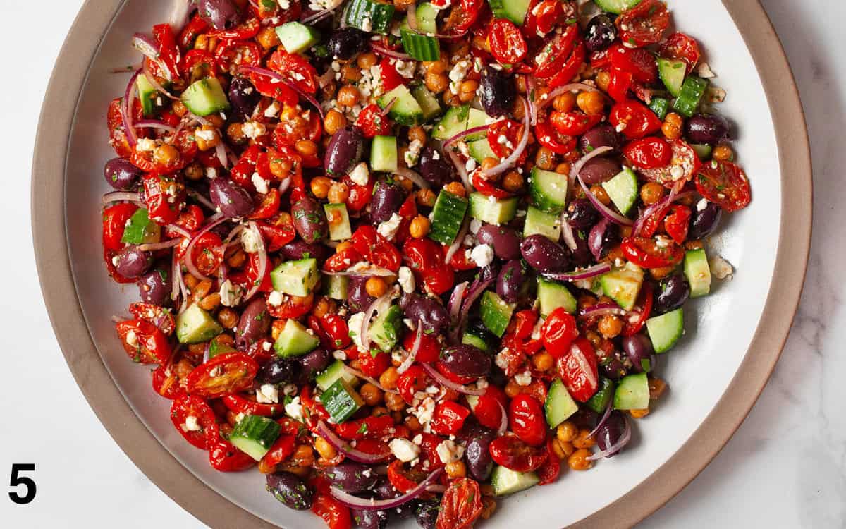 Salad tossed with vinaigrette in a large bowl.