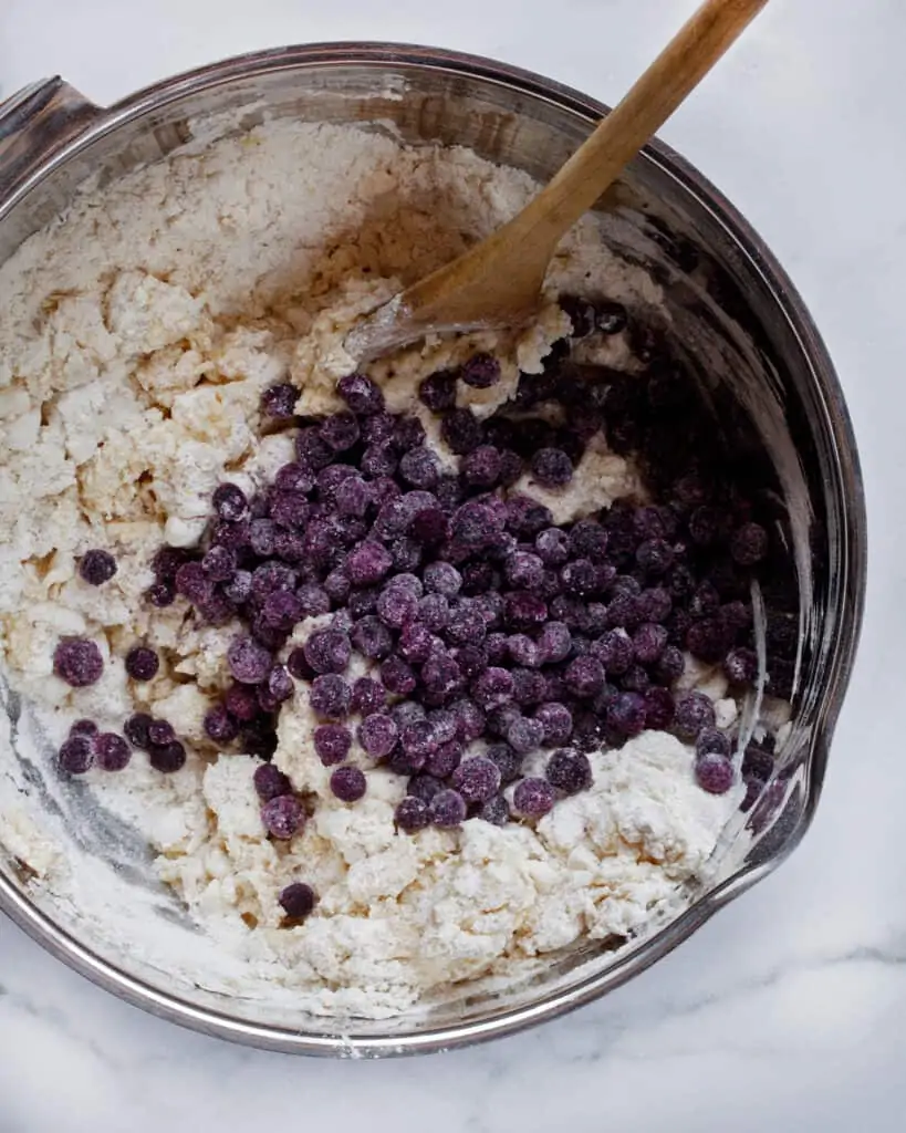 Stirring blueberries into scone dough