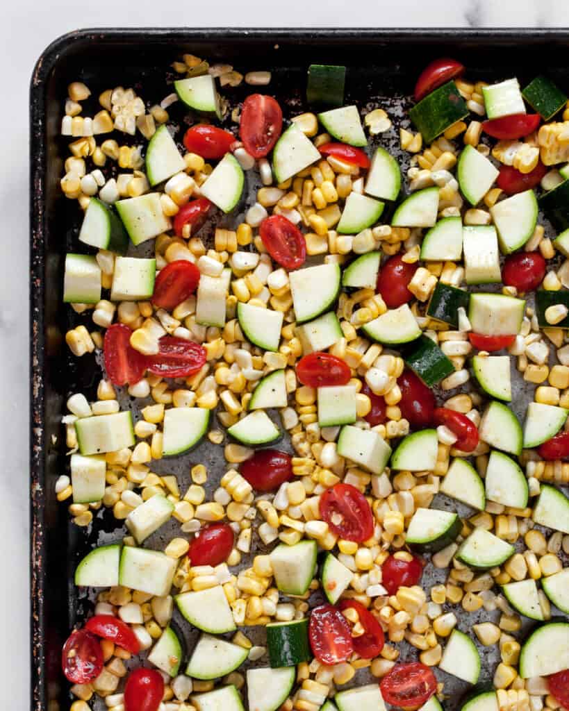 Zucchini, corn & tomatoes on a sheet pan