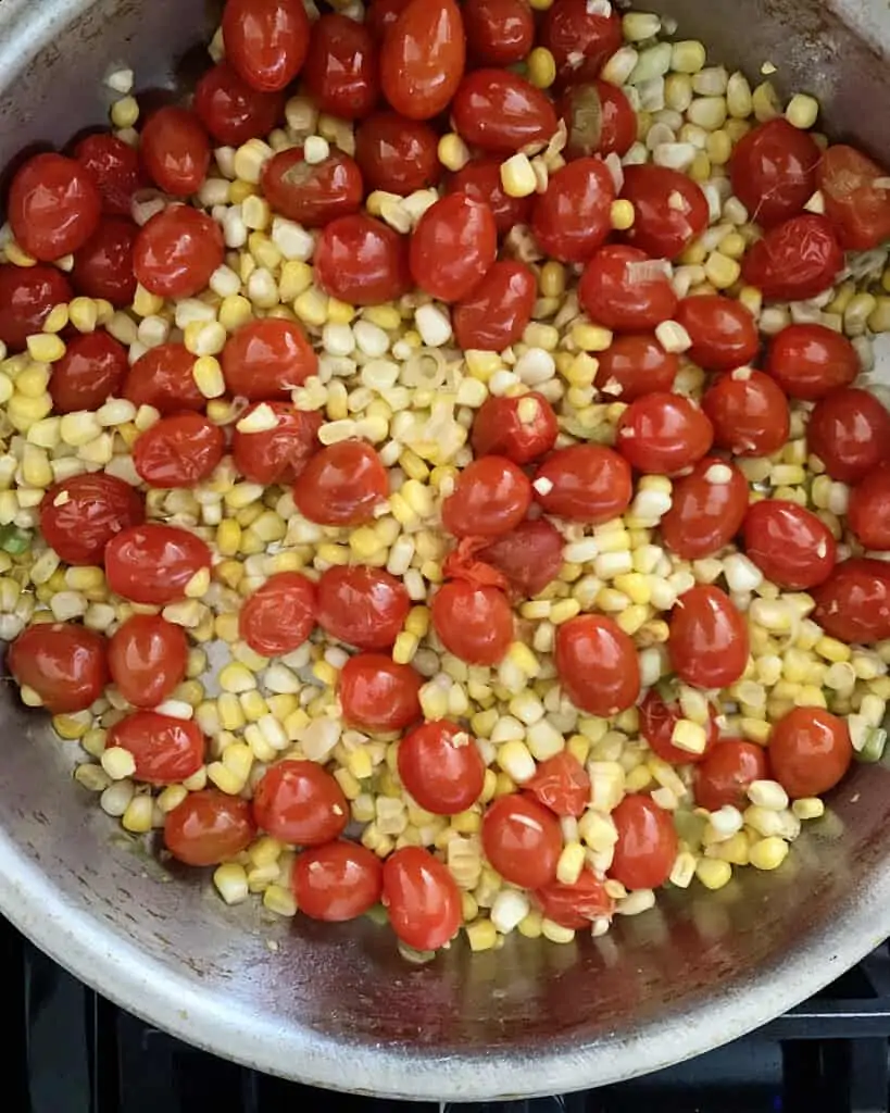 Cherry tomatoes and corn in a skillet