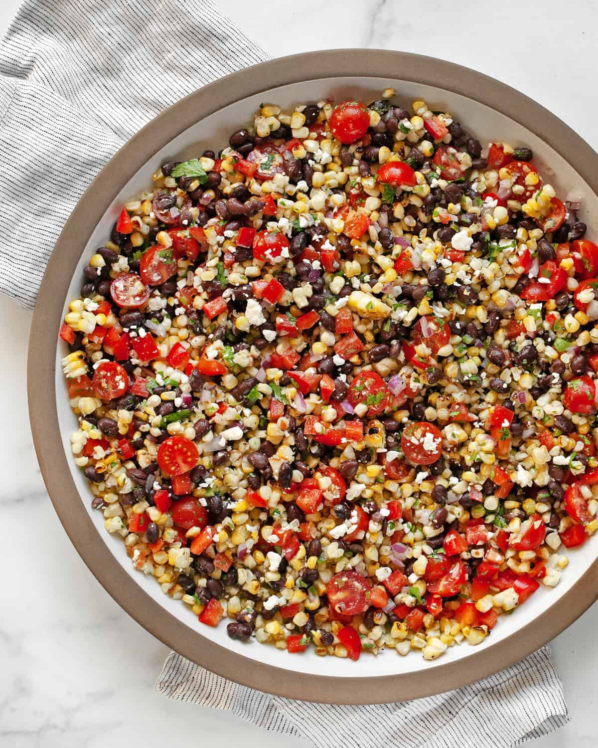 Grilled corn black bean salad in a large serving bowl.