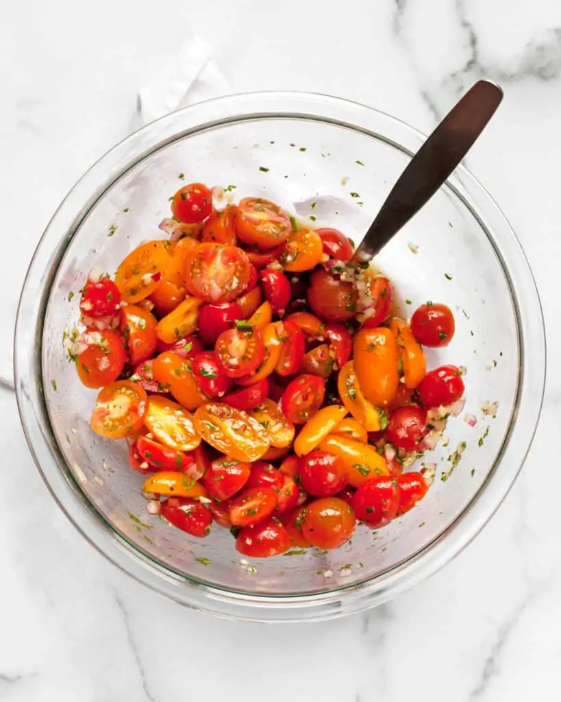 Stirring cherry tomatoes in marinade