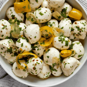 Marinated mozzarella balls in a bowl.
