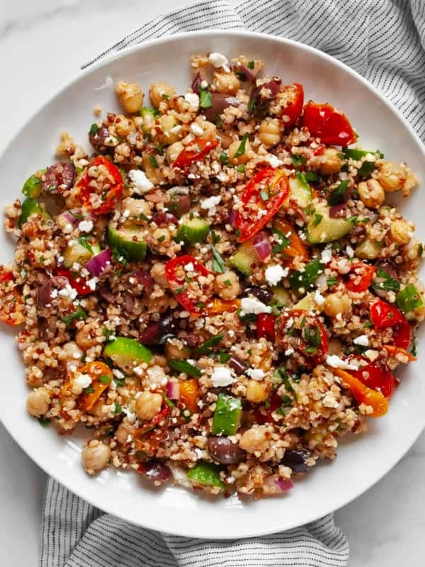Quinoa salad with chickpeas and roasted tomatoes on a plate.