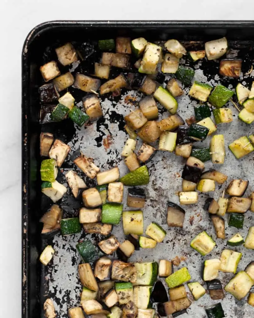 Roasted diced zucchini and eggplant on a sheet pan